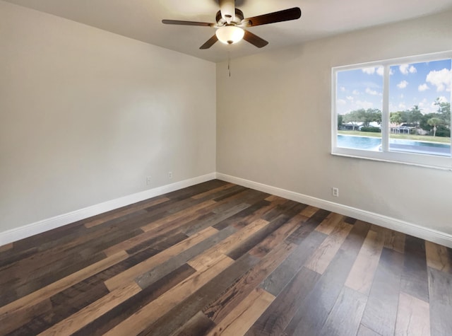 empty room featuring dark hardwood / wood-style floors and ceiling fan