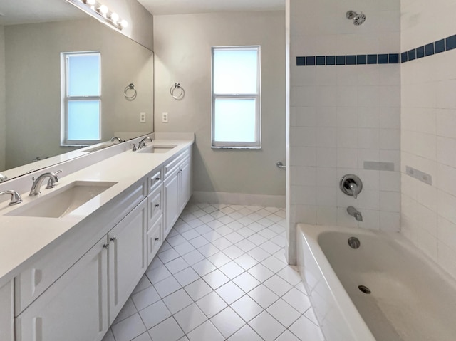 bathroom with tile patterned flooring, vanity, and tiled shower / bath