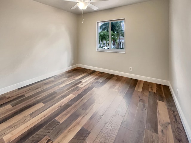 empty room featuring dark hardwood / wood-style floors and ceiling fan