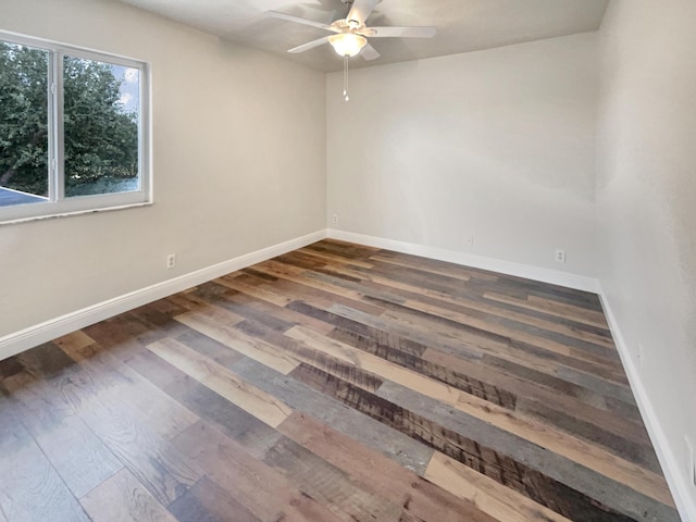 empty room featuring dark hardwood / wood-style floors and ceiling fan