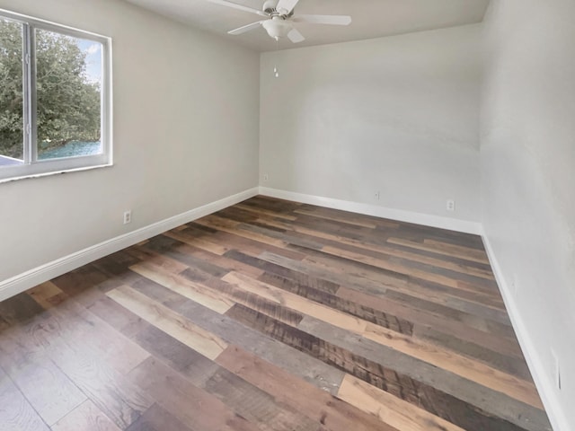 spare room with ceiling fan and dark wood-type flooring