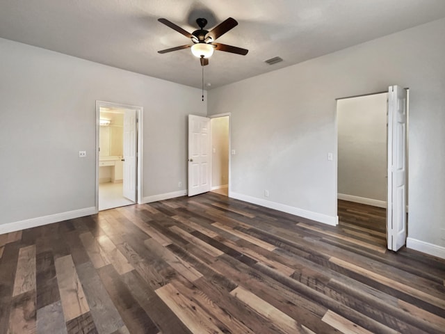 unfurnished bedroom with ceiling fan and dark wood-type flooring