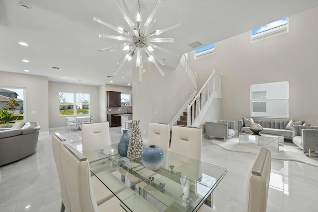 tiled dining room with an inviting chandelier