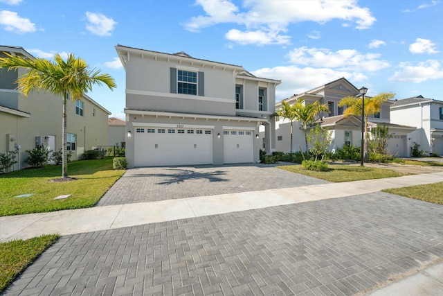 view of front facade featuring a front yard and a garage