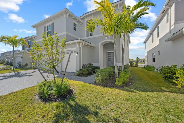 view of front of property with a garage and a front yard