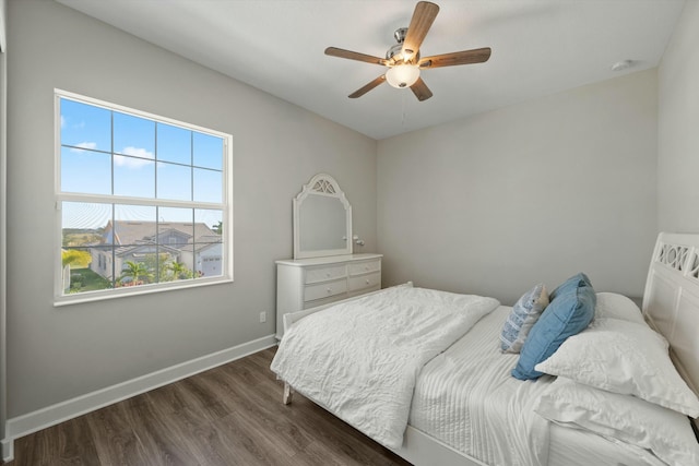 bedroom with ceiling fan and dark hardwood / wood-style floors