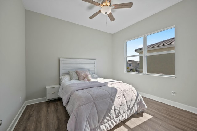 bedroom with dark hardwood / wood-style flooring and ceiling fan