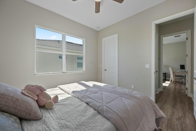 bedroom with ceiling fan and dark hardwood / wood-style floors