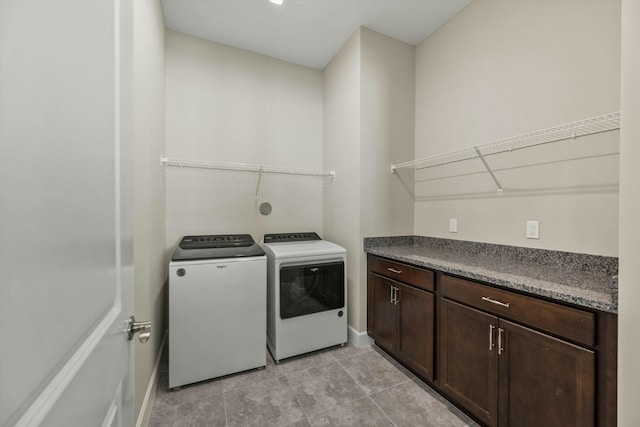 laundry room featuring washer and clothes dryer and light tile patterned floors