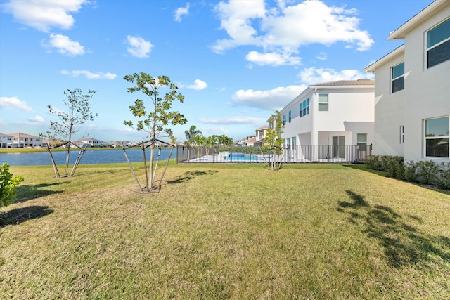 view of yard with a water view and a swimming pool