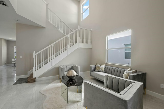 living room featuring a high ceiling