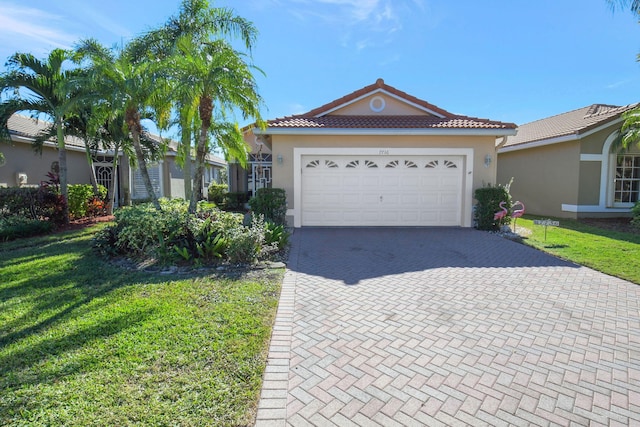 view of front of home with a garage and a front yard