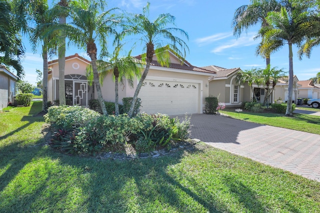 view of front of home with a front yard and a garage