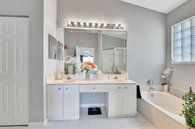 bathroom featuring tile patterned floors, vanity, and plus walk in shower