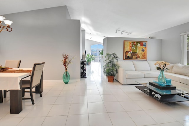 living room with rail lighting, plenty of natural light, and light tile patterned flooring