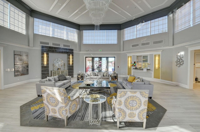 living room with a towering ceiling and an inviting chandelier