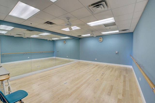 empty room featuring a paneled ceiling and hardwood / wood-style flooring