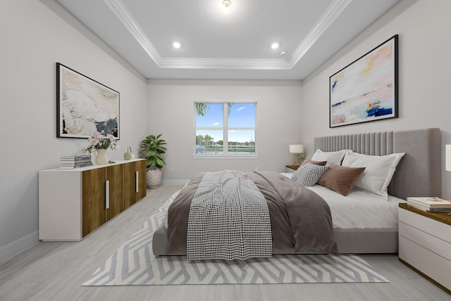 bedroom with a raised ceiling, light hardwood / wood-style flooring, and crown molding