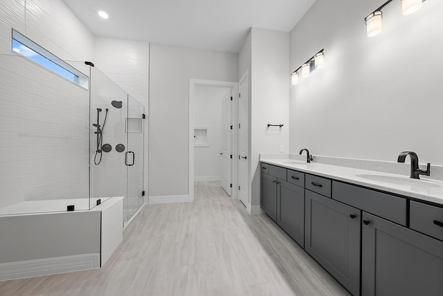 bathroom featuring hardwood / wood-style flooring, vanity, and an enclosed shower