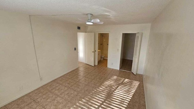 unfurnished room featuring ceiling fan and a textured ceiling