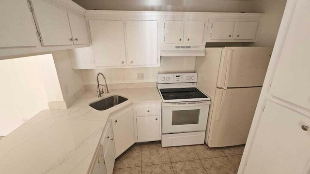 kitchen featuring white appliances, white cabinets, range hood, and sink