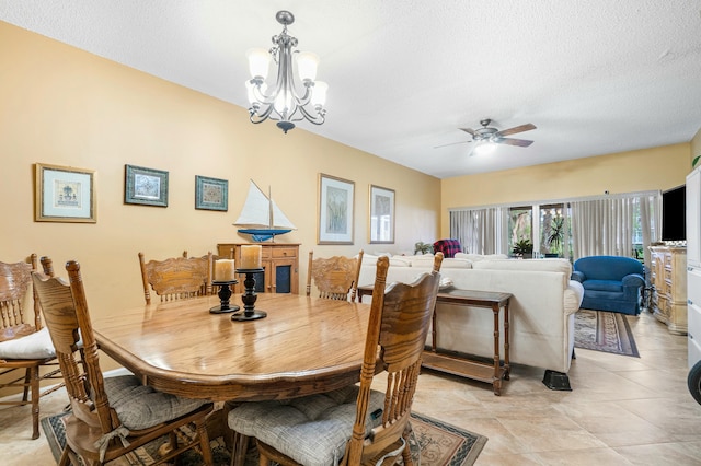 dining room featuring ceiling fan with notable chandelier and a textured ceiling