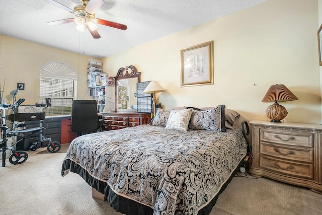 carpeted bedroom with a textured ceiling and ceiling fan