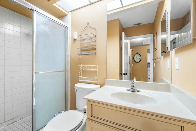 bathroom with vanity, toilet, and walk in shower