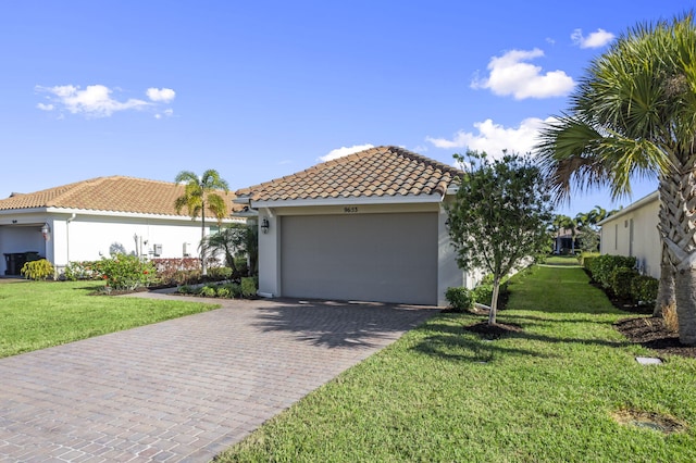 mediterranean / spanish home featuring a garage and a front lawn