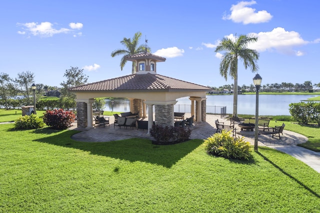 exterior space with a gazebo, a water view, a patio area, and a lawn