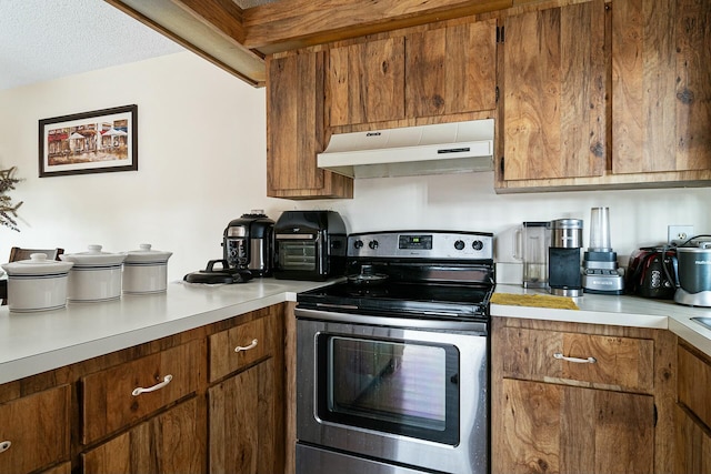 kitchen featuring stainless steel electric stove and a textured ceiling