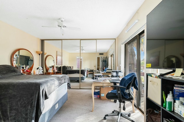 carpeted bedroom with ceiling fan and a closet