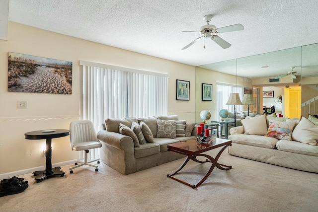 living room with a textured ceiling, ceiling fan, and light carpet