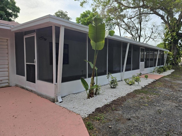 view of side of home featuring a sunroom