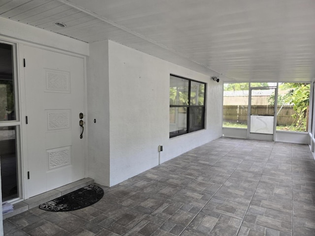 unfurnished sunroom featuring plenty of natural light