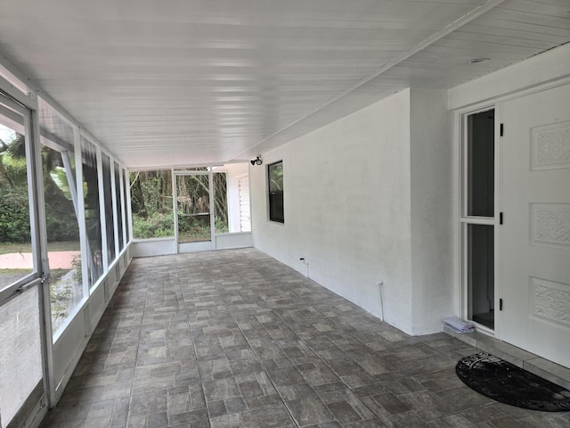 unfurnished sunroom featuring a healthy amount of sunlight