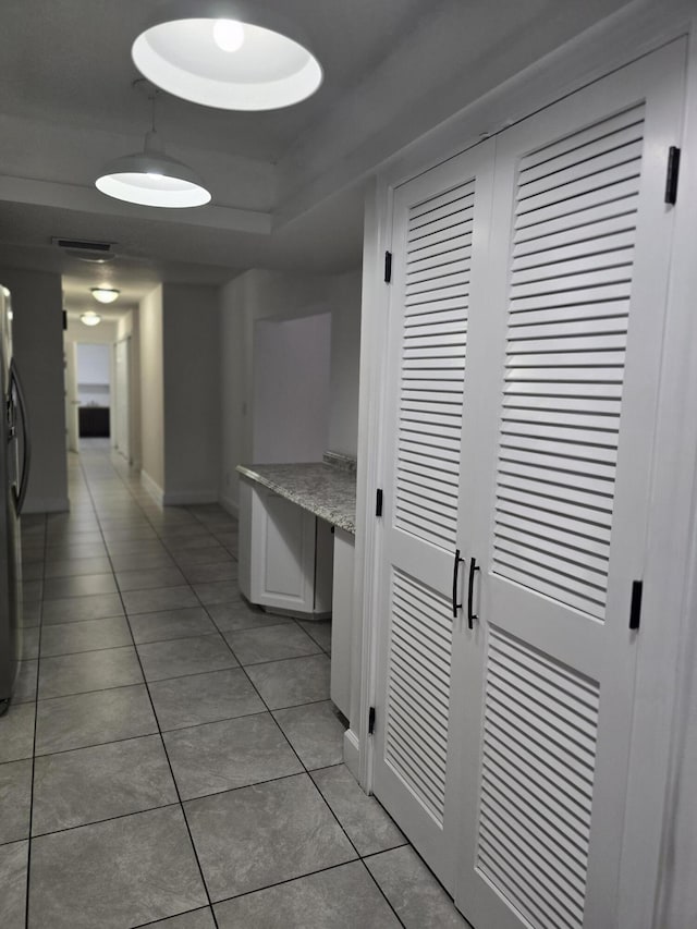 hall with light tile patterned flooring