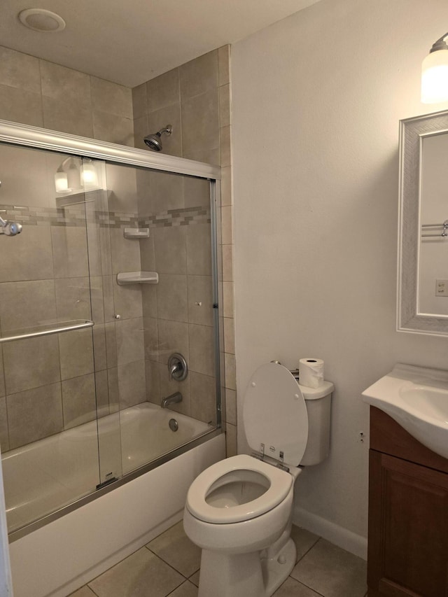 full bathroom with tile patterned flooring, toilet, combined bath / shower with glass door, and vanity