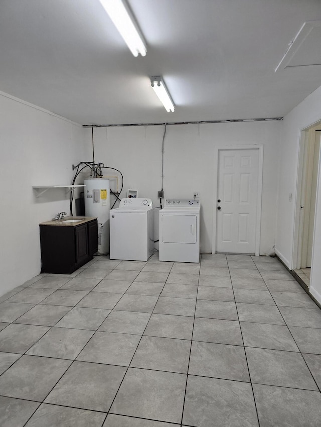 laundry room with washing machine and clothes dryer, water heater, and light tile patterned floors