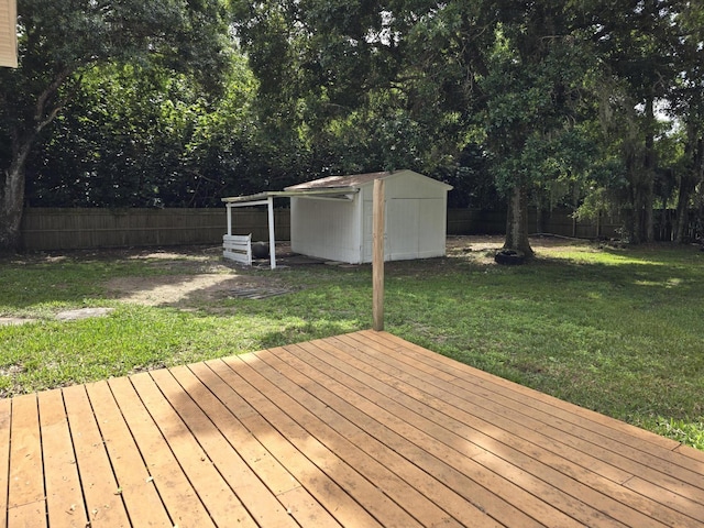 wooden deck with a yard and a shed