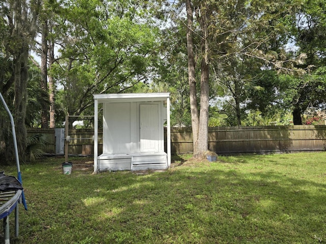 view of yard with a storage shed and a trampoline