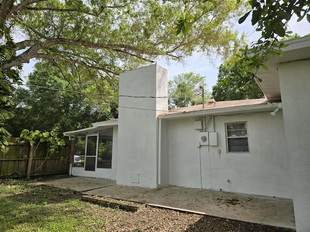 rear view of house featuring a sunroom