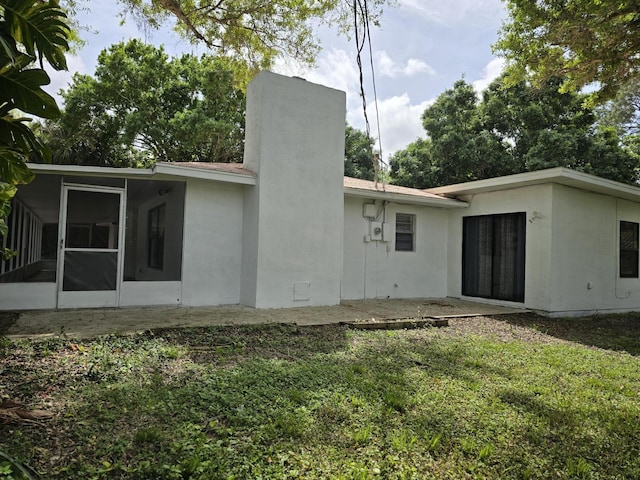 back of house featuring a sunroom