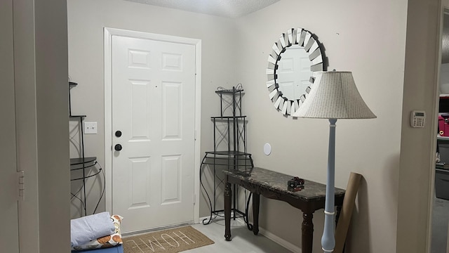 foyer entrance featuring a textured ceiling