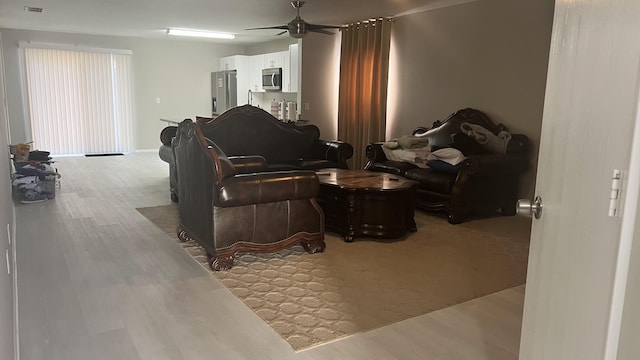 living room with ceiling fan and light hardwood / wood-style floors