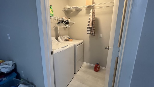 clothes washing area with washing machine and clothes dryer