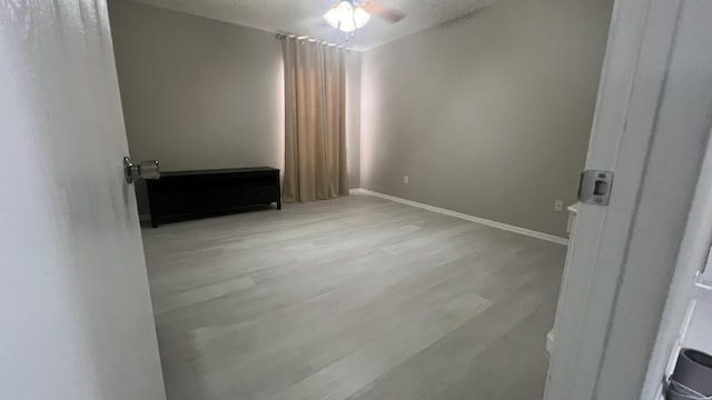 unfurnished room featuring light hardwood / wood-style flooring and ceiling fan