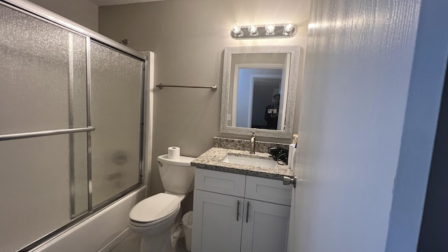 full bathroom with vanity, toilet, and bath / shower combo with glass door