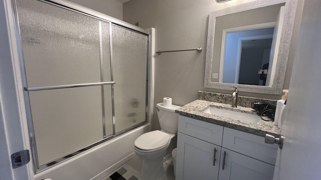 full bathroom featuring vanity, toilet, and enclosed tub / shower combo