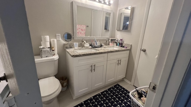 bathroom featuring tile patterned floors, vanity, and toilet